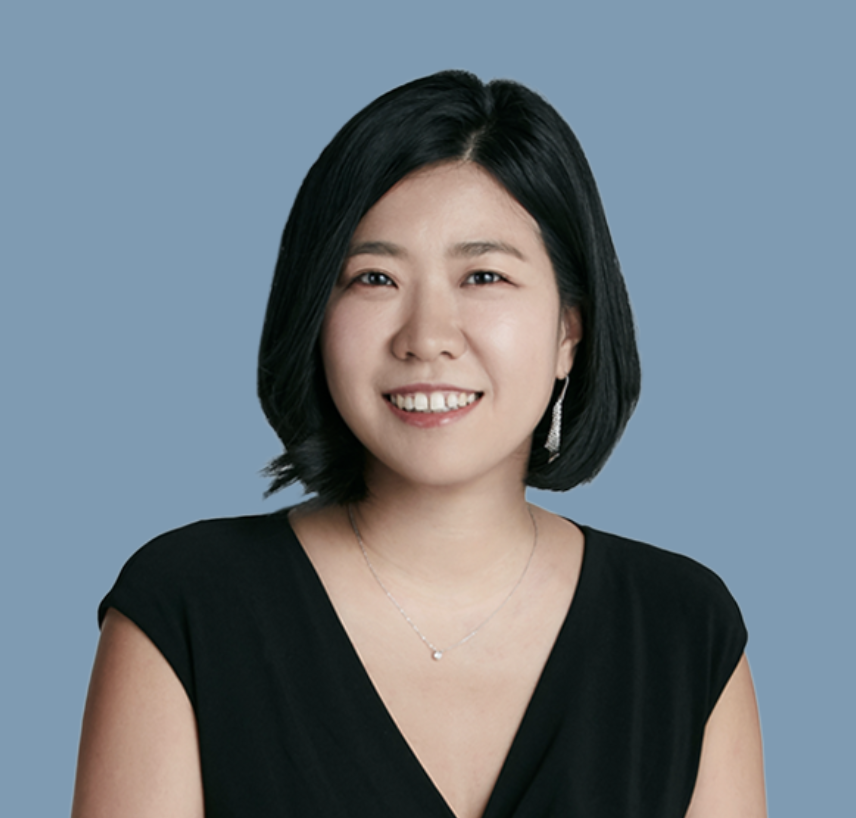 Black and white photo of a women performing modern dance on a dark background.