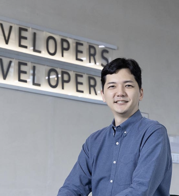 Black and white photo of a women performing modern dance on a dark background.