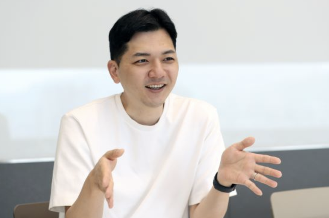 Black and white photo of a group of men performing modern dance on a stage.